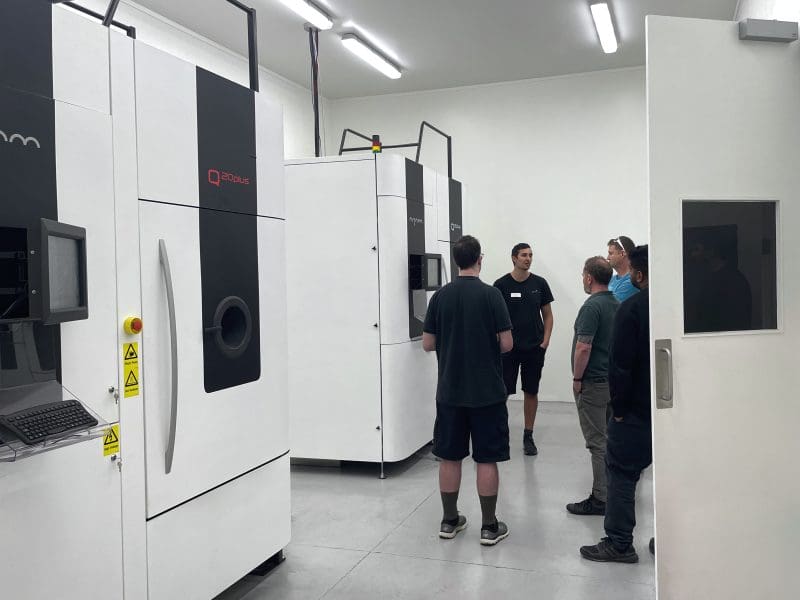 Zenith Tecnica engineer showing a group one of Zenith Tecnica's Arcam Q20+ EBM machines used for metal 3d printing